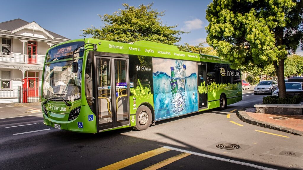 Bus driving down the street, representing a circumstance where a bus accident lawyer might be needed.