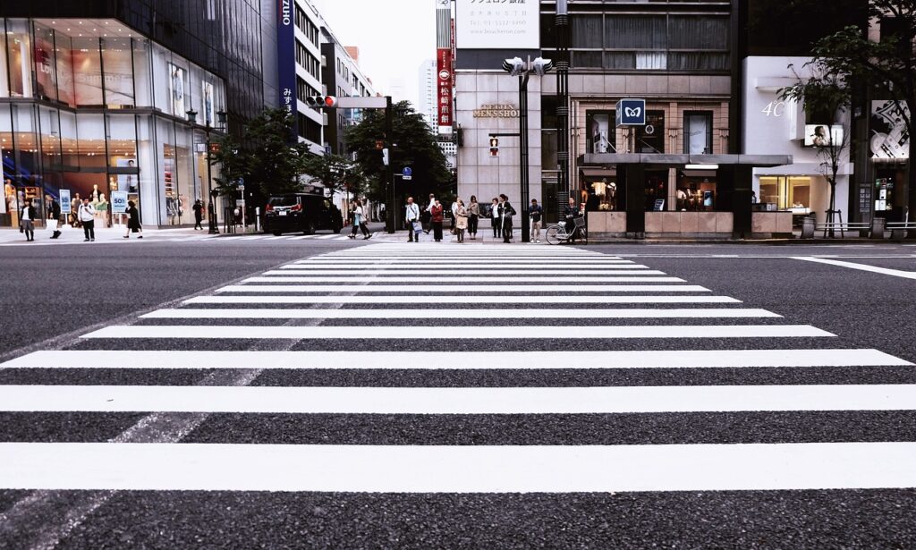 Empty crosswalk with pedestrian signals, highlighting a common location for pedestrian accidents and a circumstance when a pedestrian accident attorney would be needed.