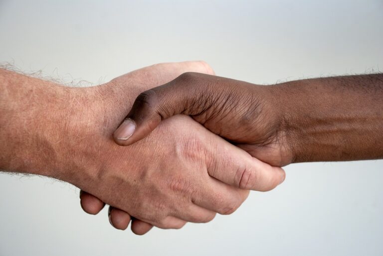 Two individuals shaking hands in a professional setting, symbolizing an agreement that may involve issues of worker misclassification, prompting the need for a 1099 attorney.