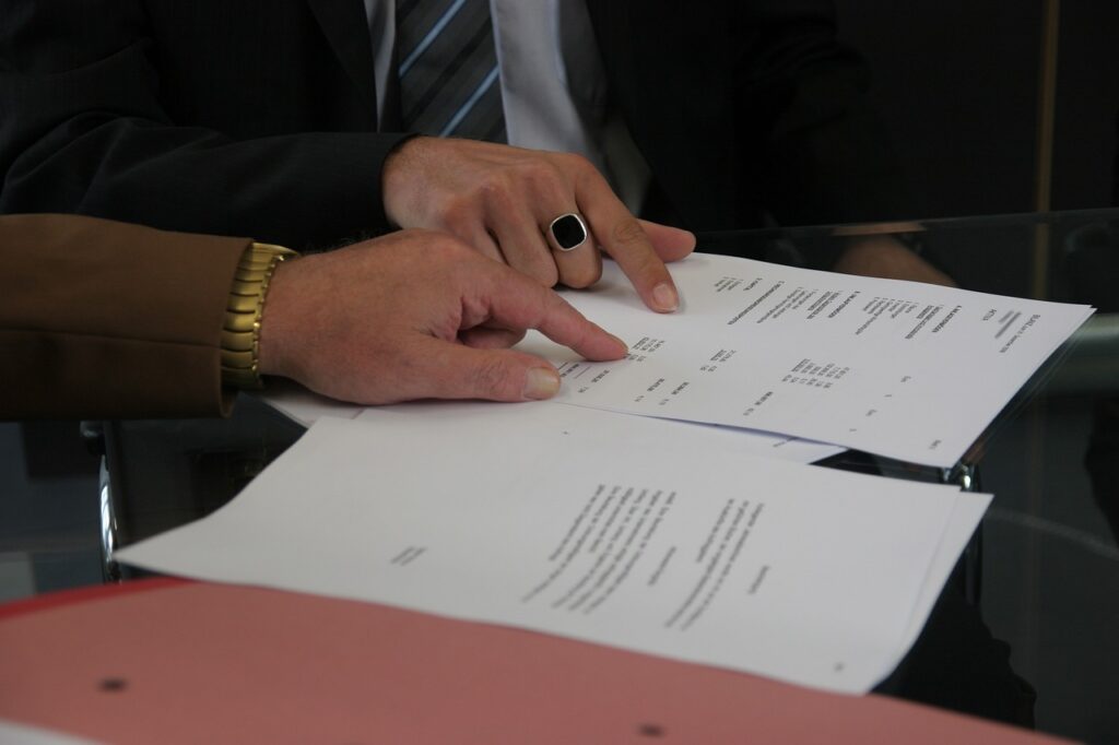 Two individuals reviewing a document together, symbolizing the collaborative examination of family medical leave - FMLA - policies