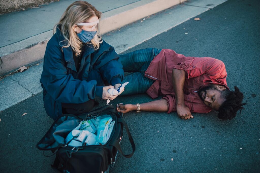 this photo depicts emergency hospital staff assisting an injured man